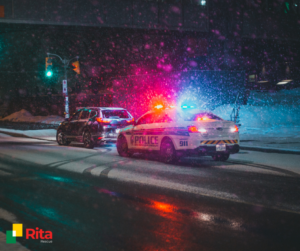 a picture of a car that is stopped on the side of the road with a police car as the car is broken
